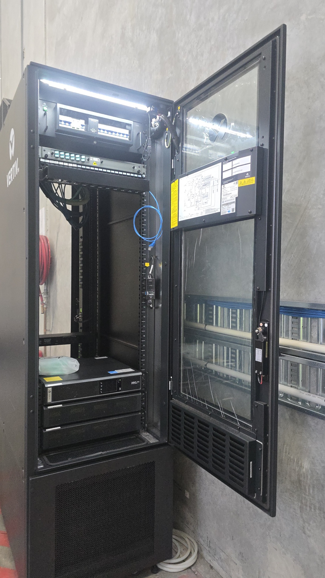 Vertiv cabinet open showing installed rack equipment